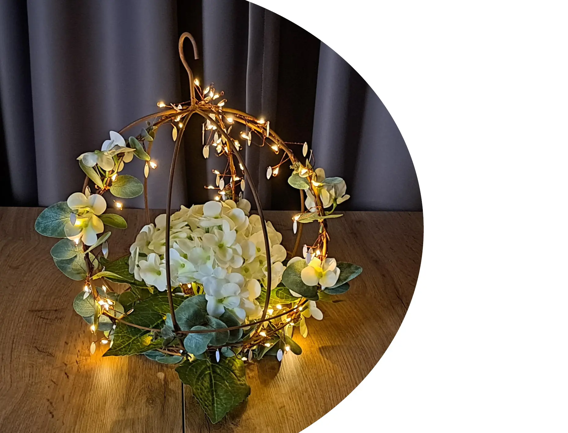 LED‑Leuchtdeko: Metall‑Hängekugel mit warmem Lichterdraht, weißen Blüten und grünen Blättern