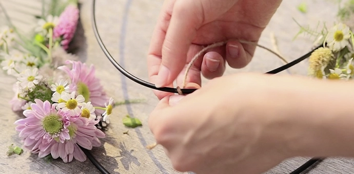 DIY‑Deko: Metallring, Juteband und rosa Blumen als Zubehör für selbstgemachte Kranzdekoration